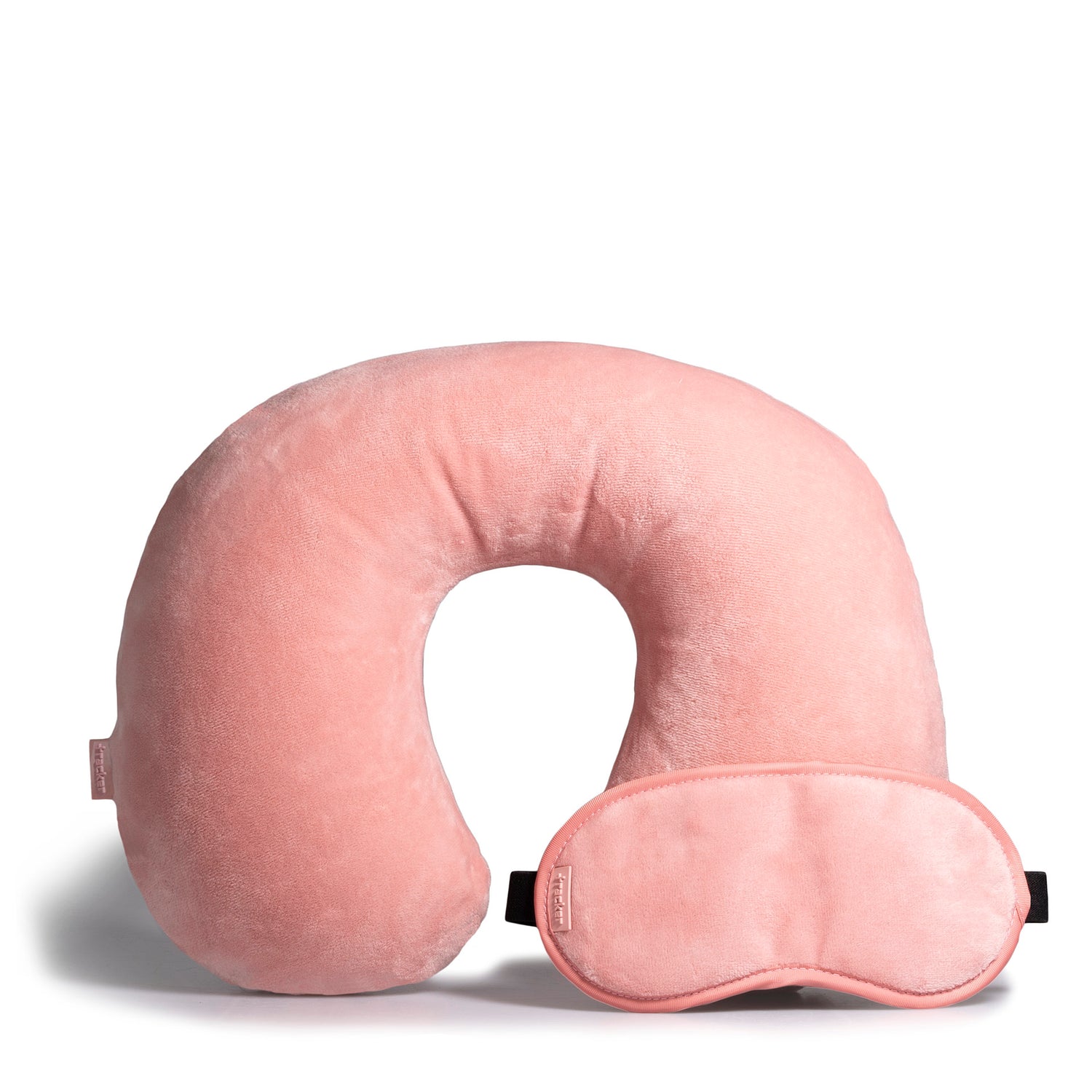 Pink travel pillow and eye mask designed by Tracker showing their plush fleece textures, and both are leaning on each other.