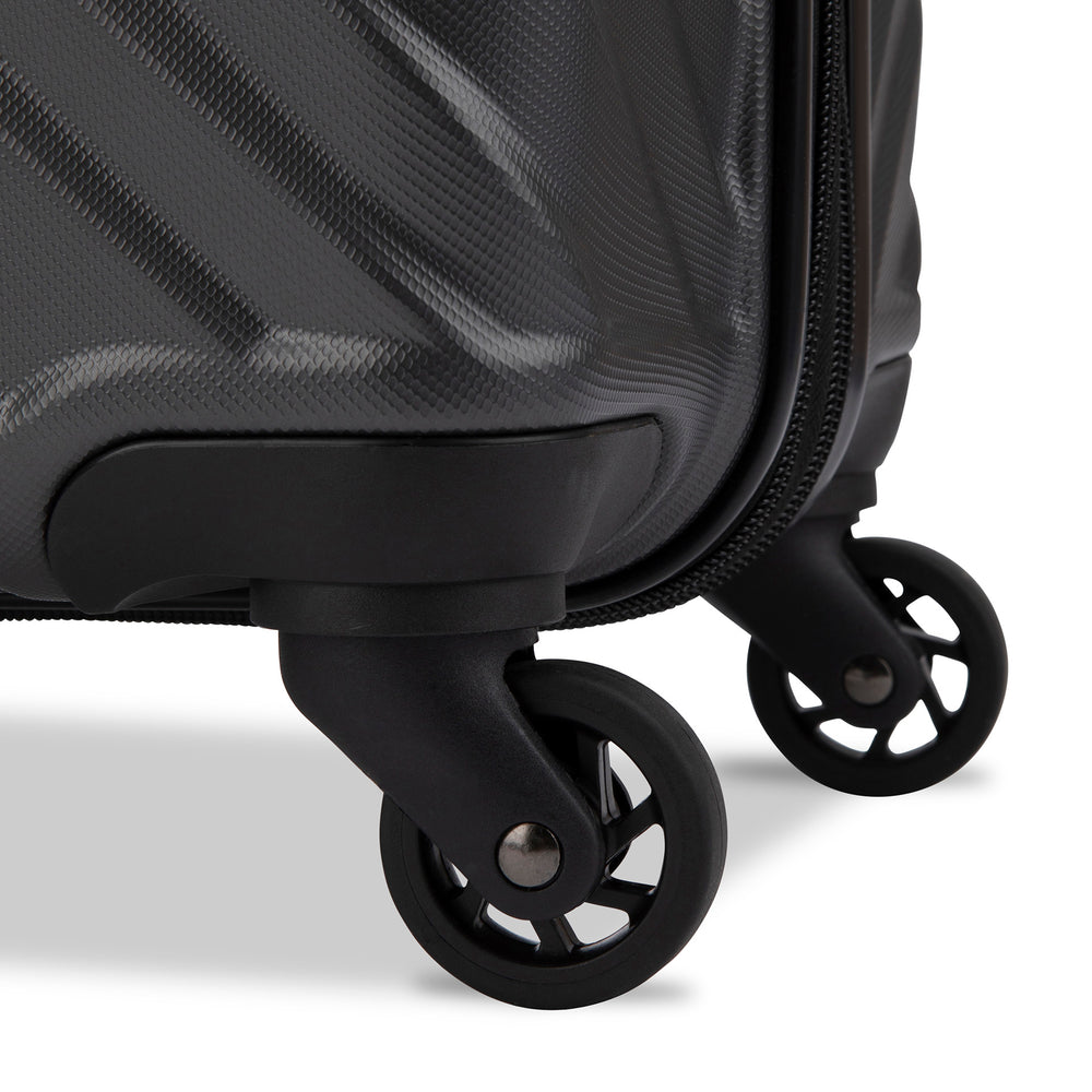Close up view of a luggage called MOD designed by Swiss Gear sold at Bentley, showcasing 2 of its 4 spinner wheels.