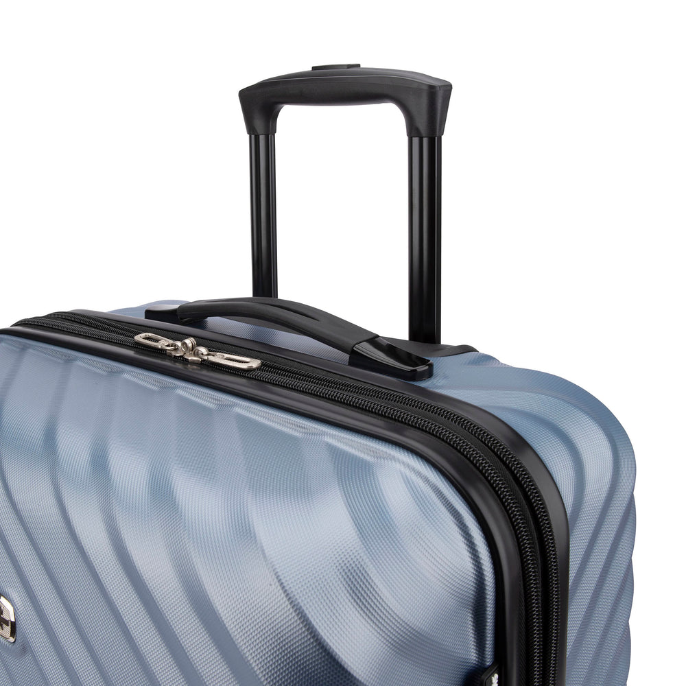 Close side view of a silverish blue hard side luggage called MOD designed by Swiss Gear sold at Bentley, showcasing its telescopic handle.