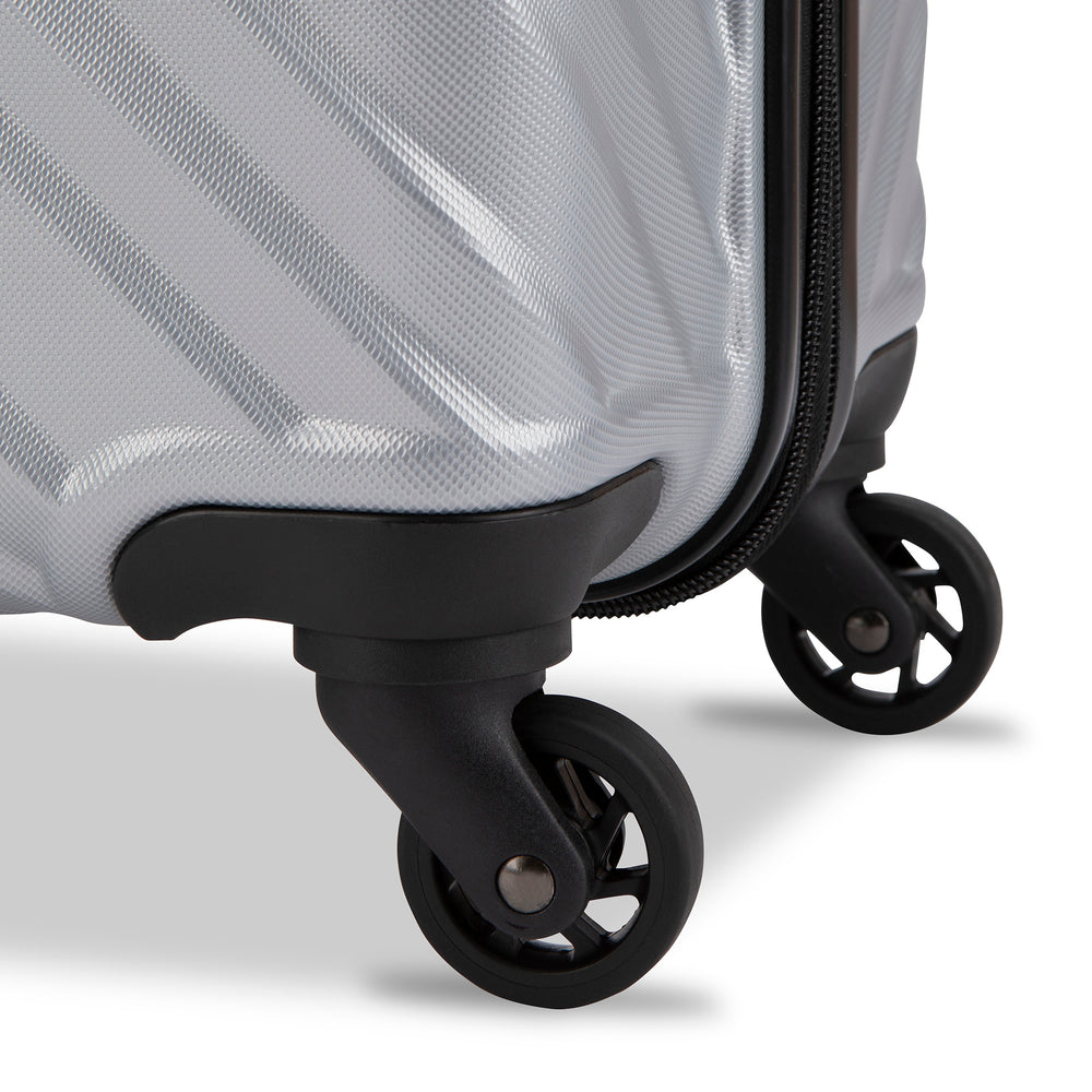 Close up view of a luggage called MOD designed by Swiss Gear sold at Bentley, showcasing 2 of its 4 spinner wheels.