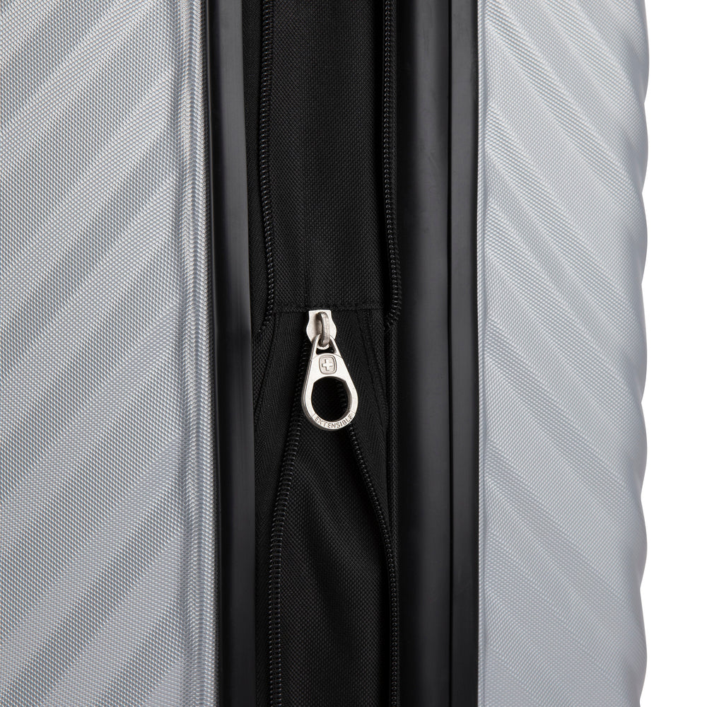 Close up view of a luggage called MOD designed by Swiss Gear sold at Bentley, showcasing its zipper pull tab with the logo