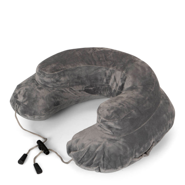 Angle view of a travel pillow from Cabeau called Air Evolution that is grey and showing its adjustment draw string strap and soft velvety texture.